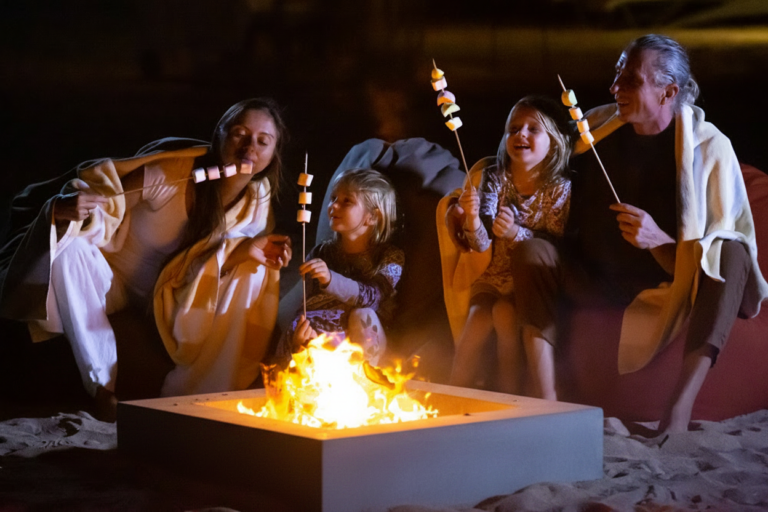 family roasting smores at beach fire pit